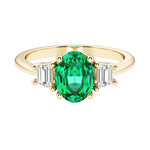 3 stone oval engagement ring with elegant proportions with green gemstone and diamonds.