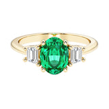 3 stone oval engagement ring with elegant proportions with green gemstone and diamonds.