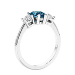 3 stone diamond engagement ring with pear shaped center in white gold.