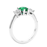 3 stone diamond engagement ring with pear shaped center in white gold featuring Colombian Green Emerald.