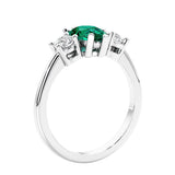 3 stone diamond engagement ring with pear shaped center in white gold featuring Green Emerald.