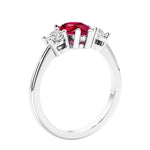 3 stone diamond engagement ring with pear shaped center in white gold featuring Ruby.