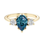Pear shaped 3 stone engagement ring with elegant diamond side stones.