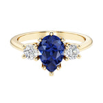 Blue Sapphire pear shaped 3 stone engagement ring with elegant diamond side stones.