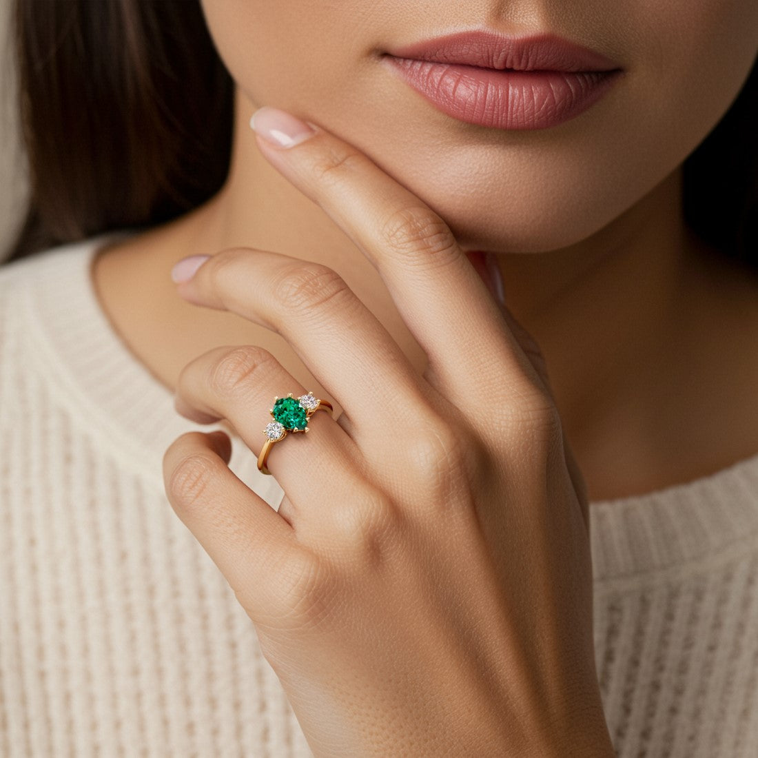 Woman wearing pear shaped three stone engagement ring with romantic flair.