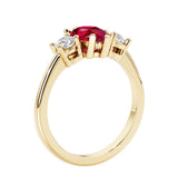 Ruby three stone pear shaped engagement ring with classic styling.