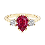 Ruby pear shaped 3 stone engagement ring with elegant diamond side stones.