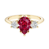 Ruby pear shaped 3 stone engagement ring with elegant diamond side stones.