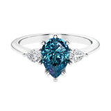 Color changing alexandrite 3 stone pear diamond ring set in a delicate band.