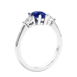 3 stone diamond engagement ring with pear shaped center in white gold featuring Blue Sapphire.