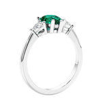 3 stone diamond engagement ring with pear shaped center in white gold featuring Green Emerald.