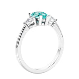 3 stone diamond engagement ring with pear shaped center in white gold featuring Paraiba Tourmaline.