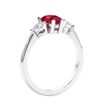 3 stone diamond engagement ring with pear shaped center in white gold featuring Red Ruby.