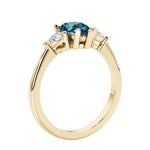 Color changing alexandrite three stone pear shaped engagement ring with classic styling.