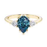 Color changing alexandrite pear shaped 3 stone engagement ring with elegant diamond side stones.