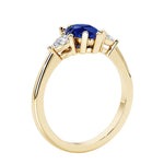Blue Sapphire three stone pear shaped engagement ring with classic styling.