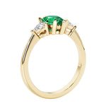Green Emerald three stone pear shaped engagement ring with classic styling.