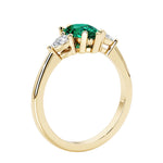 Green Emerald three stone pear shaped engagement ring with classic styling.