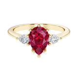 Red Ruby pear shaped 3 stone engagement ring with elegant diamond side stones.
