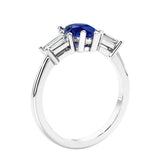 3 stone diamond engagement ring with pear shaped center in white gold featuring Blue Gemstone.