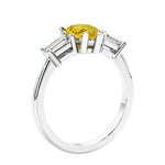 3 stone diamond engagement ring with pear shaped center in white gold featuring Yellow diamond.