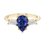 Blue Gemstone pear shaped 3 stone engagement ring with elegant diamond side stones.