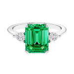 Three stone emerald cut engagement ring for timeless elegance featuring gemstone and diamonds.
