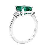 3 stone emerald cut diamond ring in modern gold setting with gemstone center.