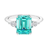 Three stone emerald cut engagement ring for timeless elegance featuring gemstone and diamonds.