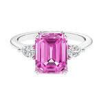 Three stone emerald cut engagement ring for timeless elegance featuring gemstone and diamonds.