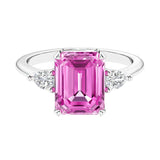 Three stone emerald cut engagement ring for timeless elegance featuring gemstone and diamonds.