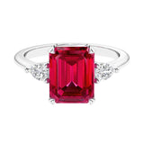 Three stone emerald cut engagement ring for timeless elegance featuring gemstone and diamonds.