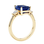 Emerald cut 3 diamond ring representing past, present, and future featuring gemstone center.