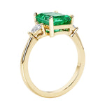 Emerald cut 3 diamond ring representing past, present, and future featuring gemstone center.