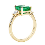 Emerald cut 3 diamond ring representing past, present, and future featuring gemstone center.