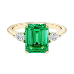 Emerald cut 3 stone engagement ring with gemstone and diamond accents.