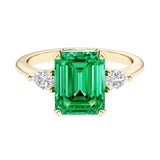 Emerald cut 3 stone engagement ring with gemstone and diamond accents.