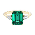 Emerald cut 3 stone engagement ring with gemstone and diamond accents.