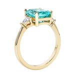 Emerald cut 3 diamond ring representing past, present, and future featuring gemstone center.