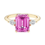 Emerald cut 3 stone engagement ring with gemstone and diamond accents.