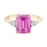 Emerald cut 3 stone engagement ring with gemstone and diamond accents.
