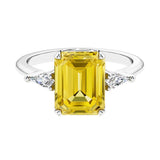 Three stone emerald cut engagement ring for timeless elegance featuring pink gemstone and diamonds.