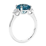 Cushion cut diamond ring as a unique engagement ring featuring three stone design.