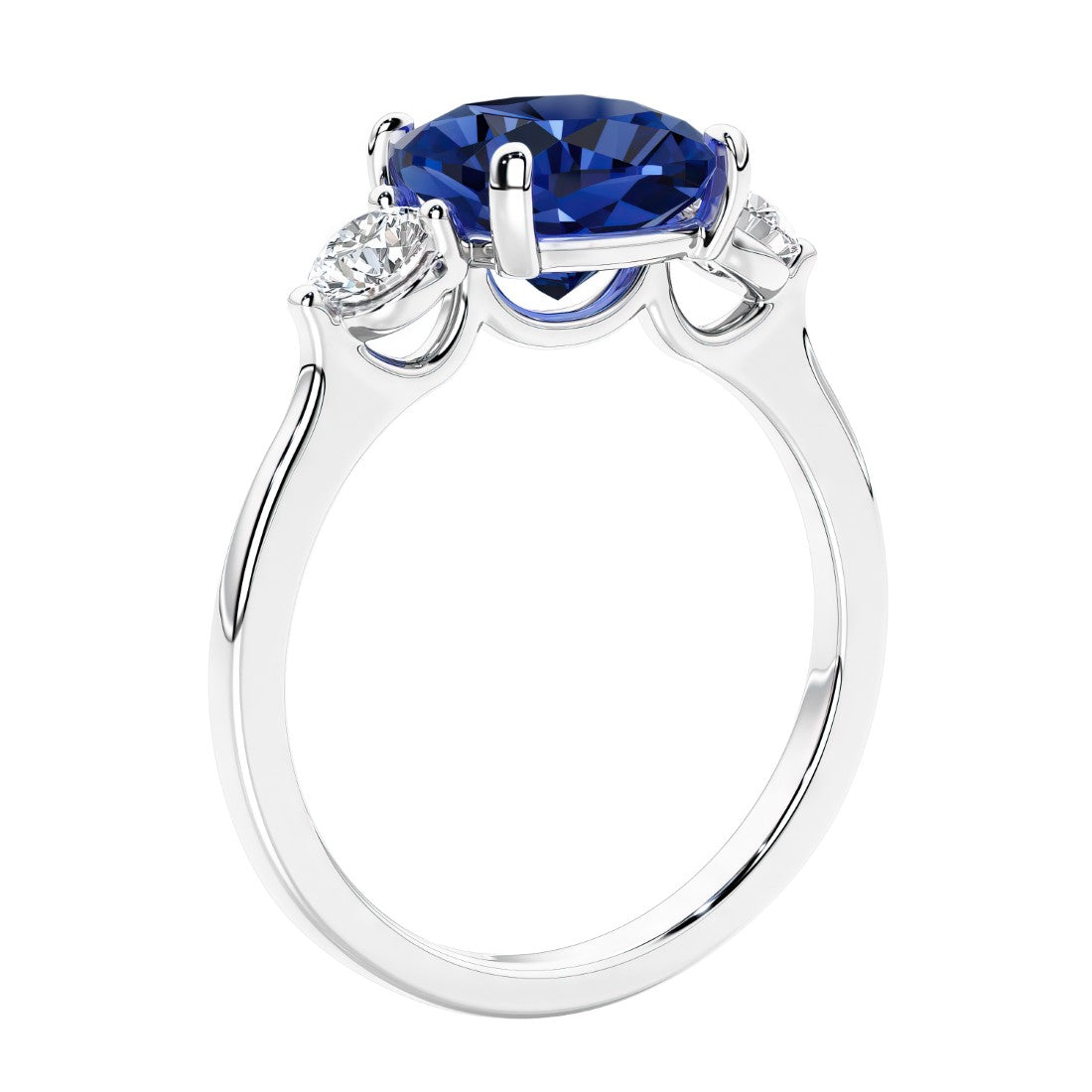 Cushion cut diamond ring with blue sapphire as a unique engagement ring featuring three stone design.
