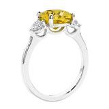 Cushion cut diamond ring as a unique engagement ring featuring three stone design. 