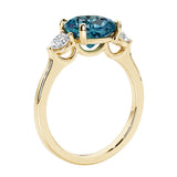 Three stone cushion diamond ring in yellow gold setting.