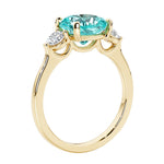 Three stone cushion diamond ring in yellow gold setting.