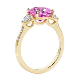 Three stone cushion diamond ring in yellow gold setting.