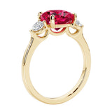 Three stone cushion diamond ring in yellow gold setting.