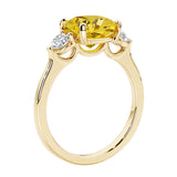 Three stone cushion diamond ring in yellow gold setting.